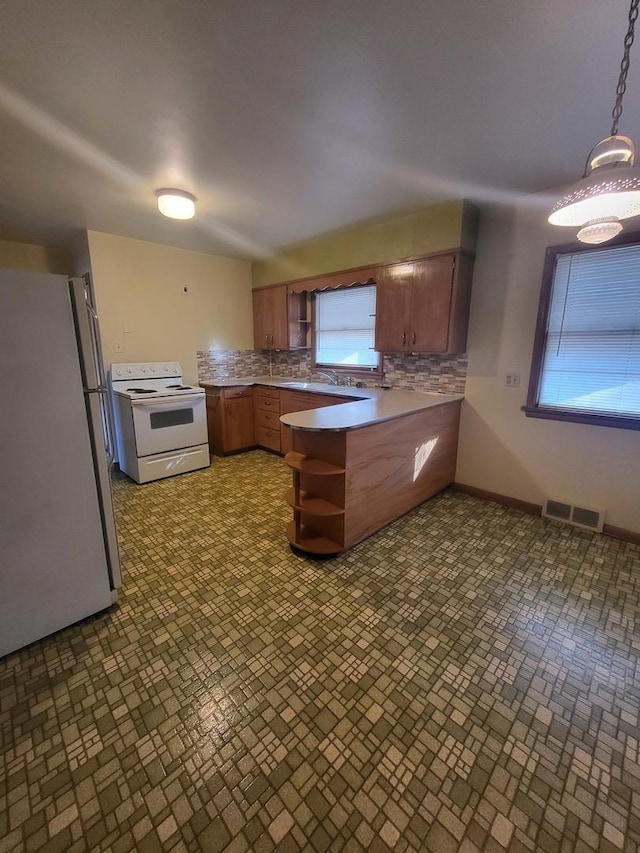 kitchen featuring a peninsula, white appliances, visible vents, backsplash, and open shelves