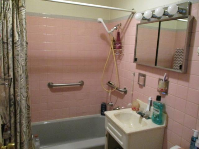 bathroom with shower / bath combo, decorative backsplash, tile walls, and vanity