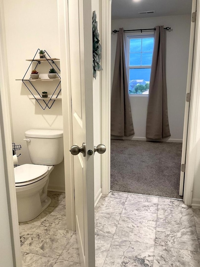 1315 Stonecrop Ln, Joliet, IL 60431 - bathroom with marble look tiles, toilet, and baseboards