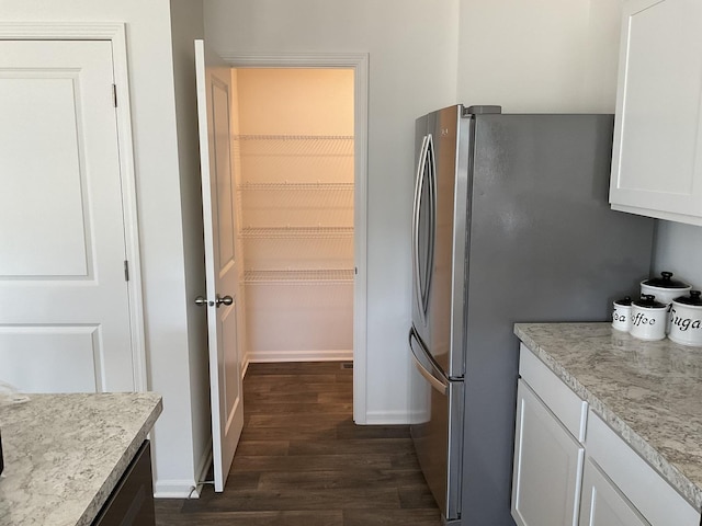 1315 Stonecrop Ln, Joliet, IL 60431 - kitchen with dark wood-style floors, freestanding refrigerator, white cabinets, light countertops, and baseboards