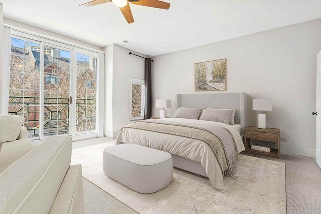 carpeted bedroom with visible vents, baseboards, and a ceiling fan