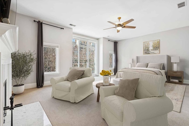 bedroom featuring a ceiling fan, light colored carpet, visible vents, and baseboards