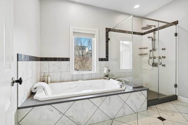 bathroom featuring a stall shower, recessed lighting, and a bath