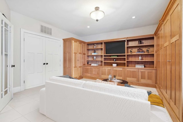 living area featuring light tile patterned floors, visible vents, and recessed lighting