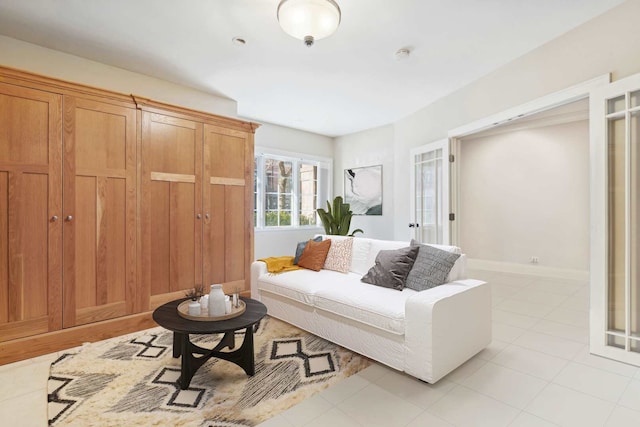 living area with light tile patterned floors and baseboards