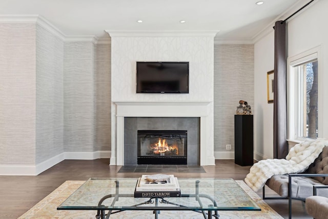 living room with a fireplace, baseboards, and wood finished floors