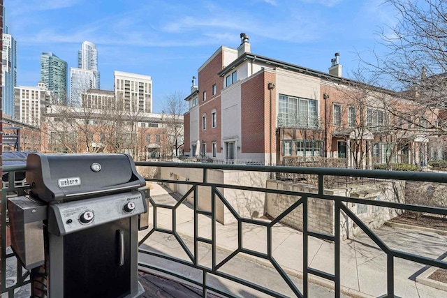 balcony with a city view and area for grilling