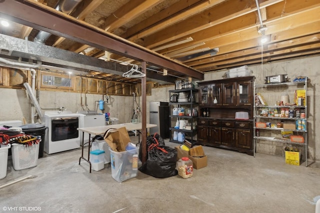 unfinished basement with freestanding refrigerator and washing machine and dryer