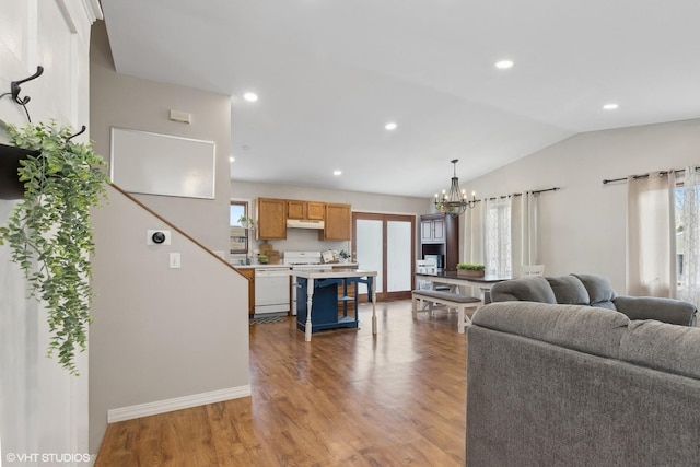 living area with light wood finished floors, lofted ceiling, recessed lighting, a chandelier, and baseboards