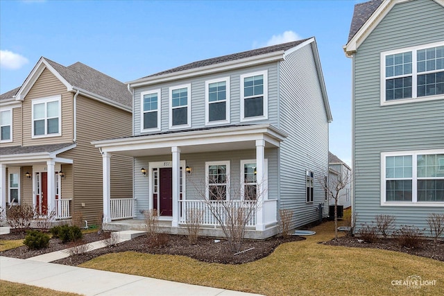 traditional-style home featuring a porch and a front lawn