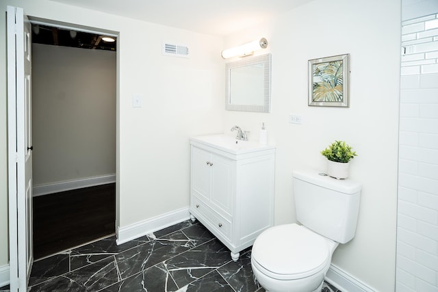 bathroom featuring marble finish floor, visible vents, baseboards, and toilet