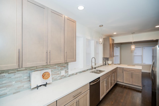 kitchen featuring dark wood-style floors, tasteful backsplash, light countertops, appliances with stainless steel finishes, and a sink