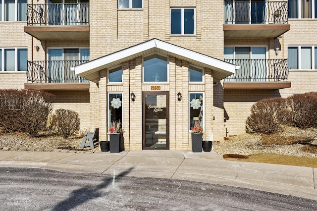 doorway to property with brick siding