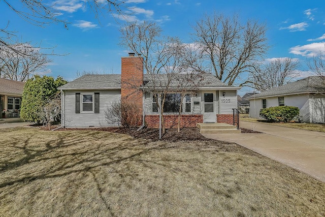 single story home featuring crawl space, brick siding, a chimney, and a front lawn