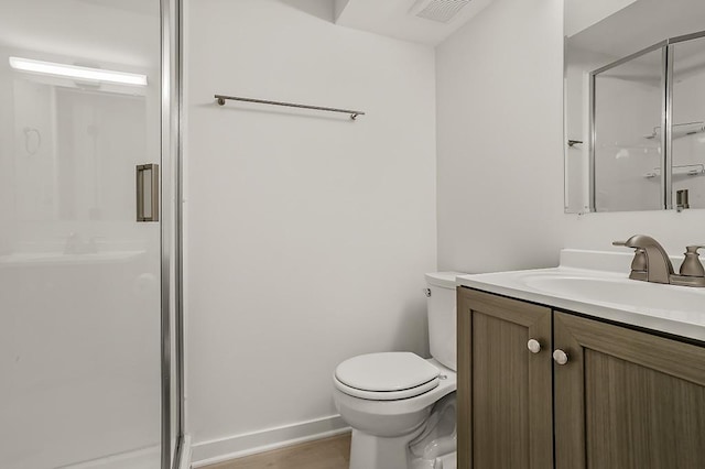 bathroom featuring visible vents, a stall shower, toilet, and vanity