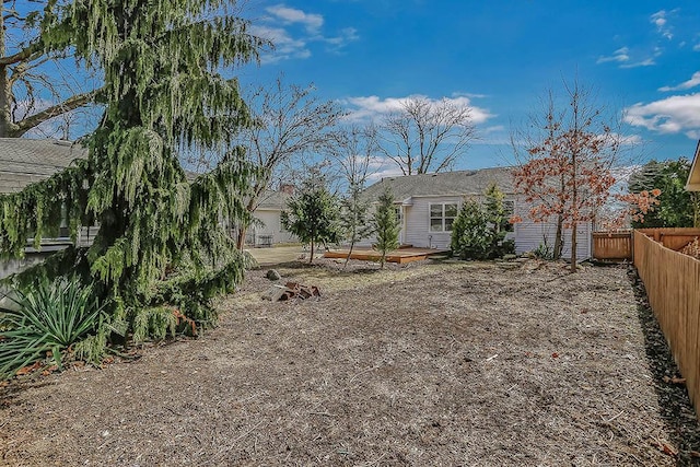 view of yard featuring a fenced backyard and a wooden deck