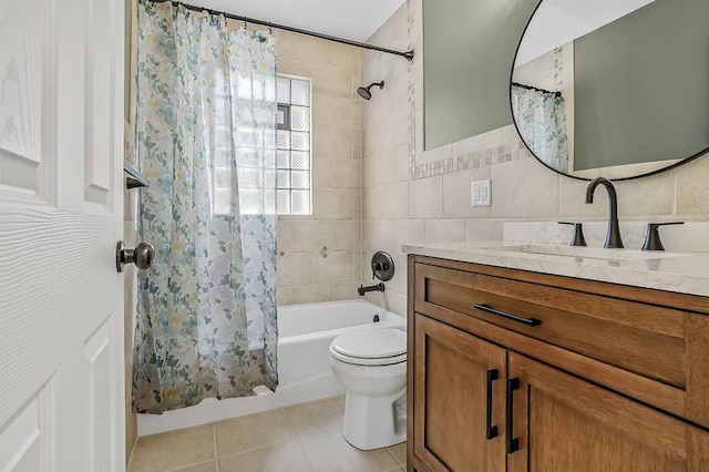 bathroom with tile patterned floors, toilet, tile walls, shower / bath combination with curtain, and vanity