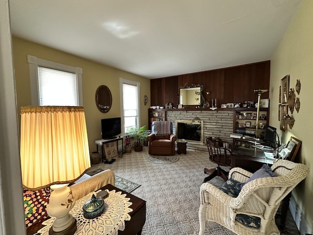 living area with carpet floors and a glass covered fireplace