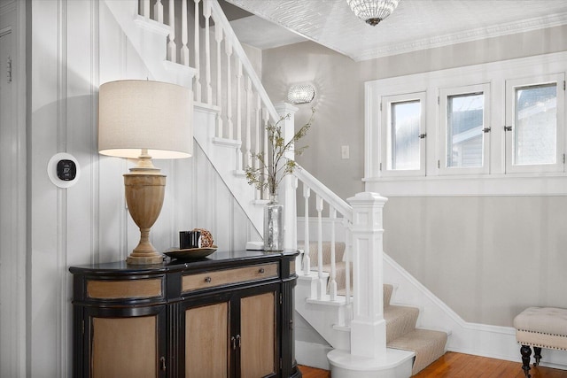 staircase with wood finished floors and baseboards