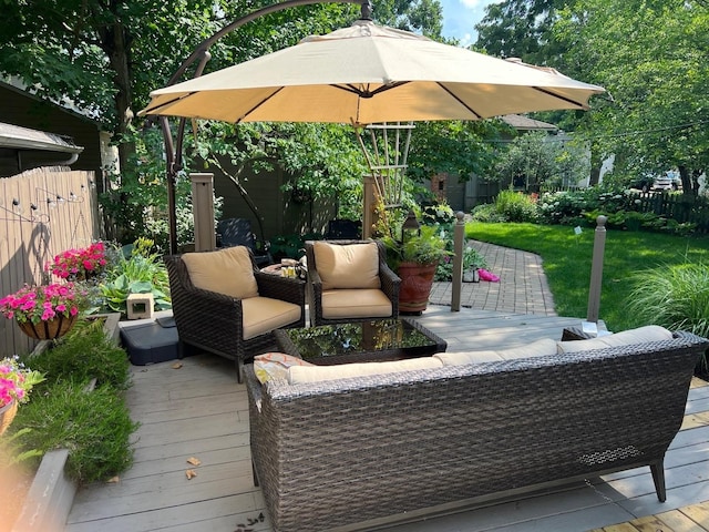 wooden terrace featuring outdoor lounge area and fence