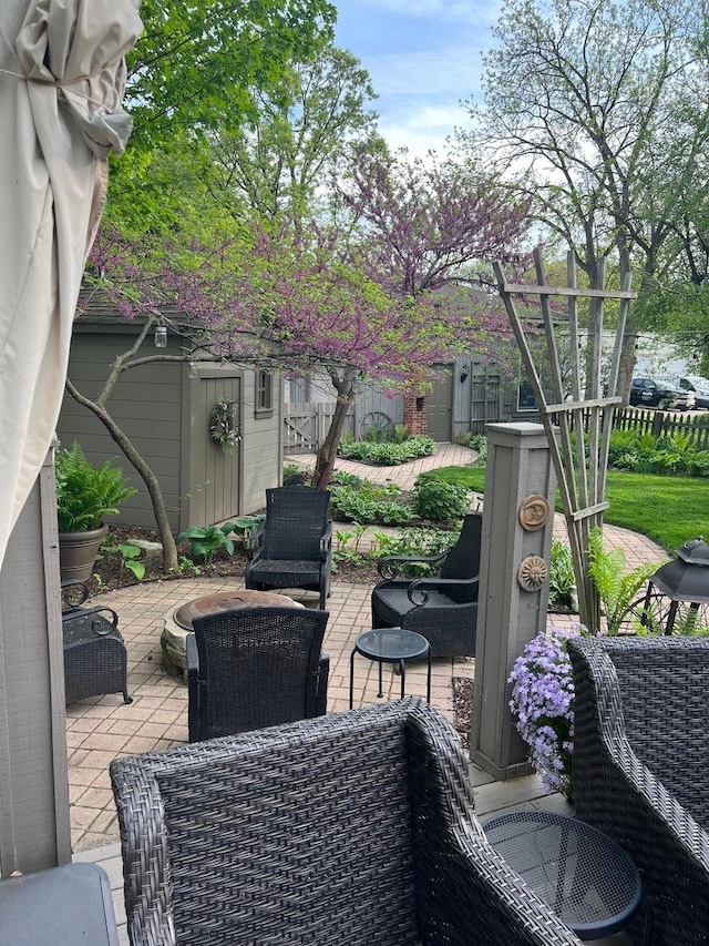 view of patio with an outbuilding and a shed