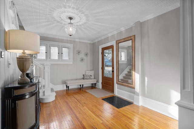 entrance foyer with hardwood / wood-style flooring, baseboards, stairway, and a wealth of natural light