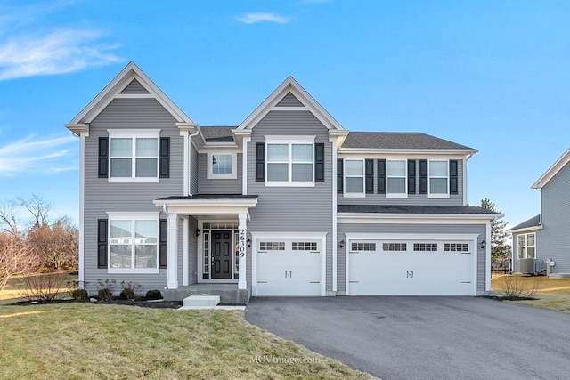 view of front of property with driveway, a front lawn, and an attached garage