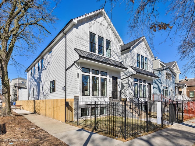 view of front of property with a fenced front yard and board and batten siding