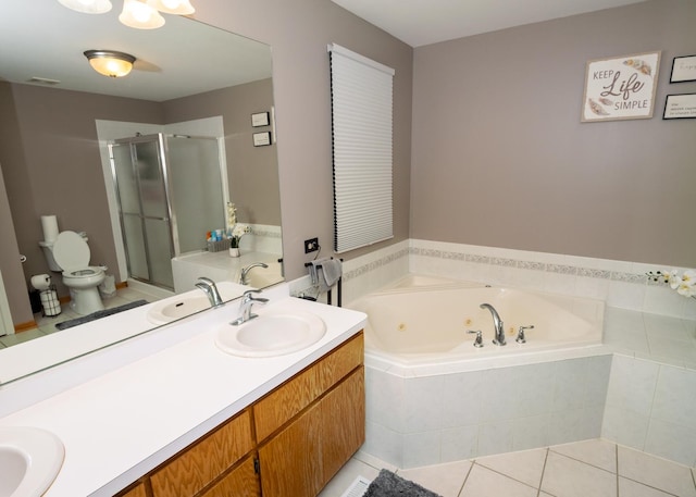 bathroom featuring a shower stall, double vanity, a sink, and tile patterned floors