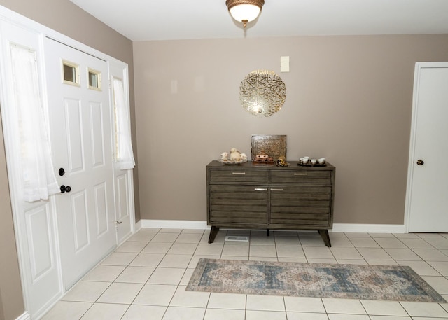 entryway featuring light tile patterned floors and baseboards