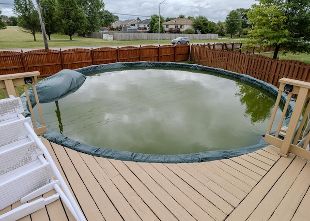 view of swimming pool with fence