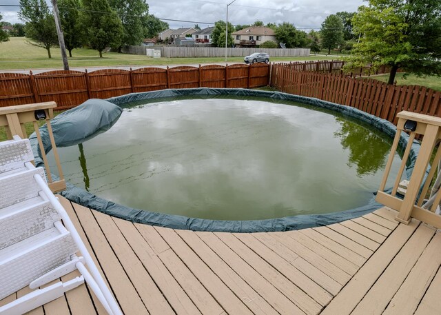 wooden deck with a grill and fence