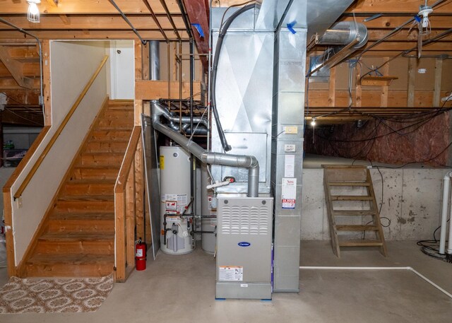 utility room featuring gas water heater and heating unit