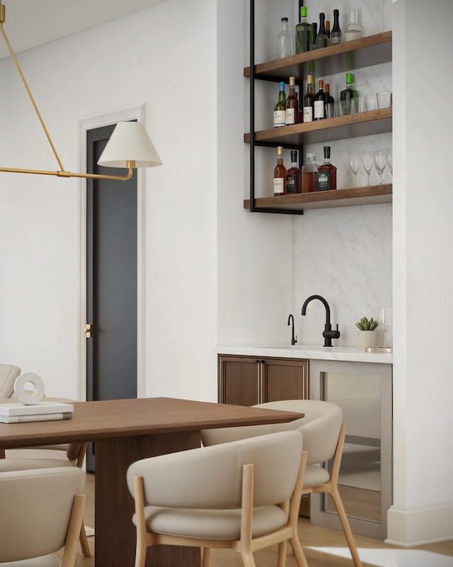 bar featuring tasteful backsplash and indoor wet bar