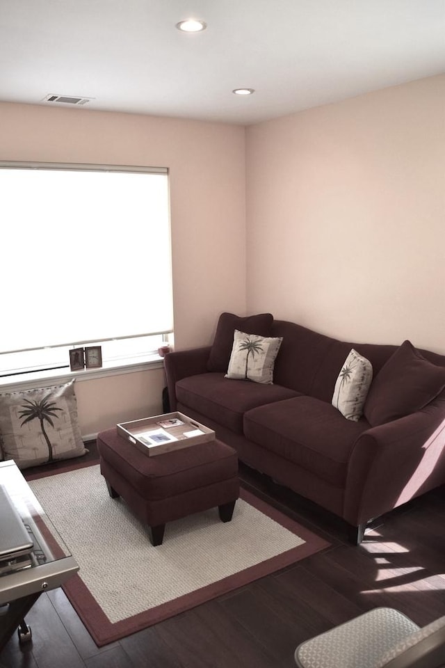 living room with visible vents, recessed lighting, and wood finished floors