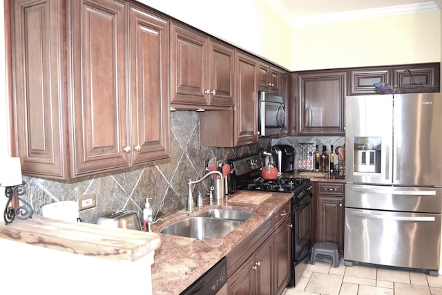 kitchen featuring light stone countertops, a sink, ornamental molding, stainless steel appliances, and backsplash