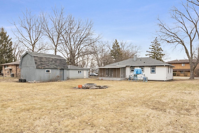 view of yard with a barn, a sunroom, and an outdoor structure