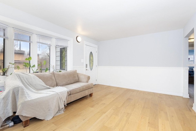 living room featuring baseboards and light wood finished floors