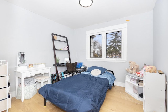 bedroom featuring wood finished floors and baseboards