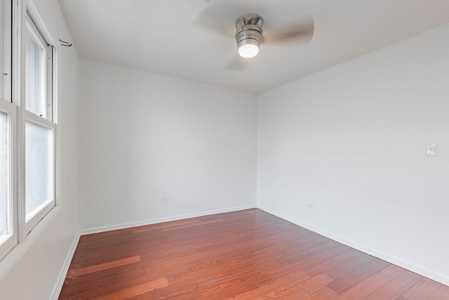 spare room with ceiling fan, baseboards, and wood finished floors