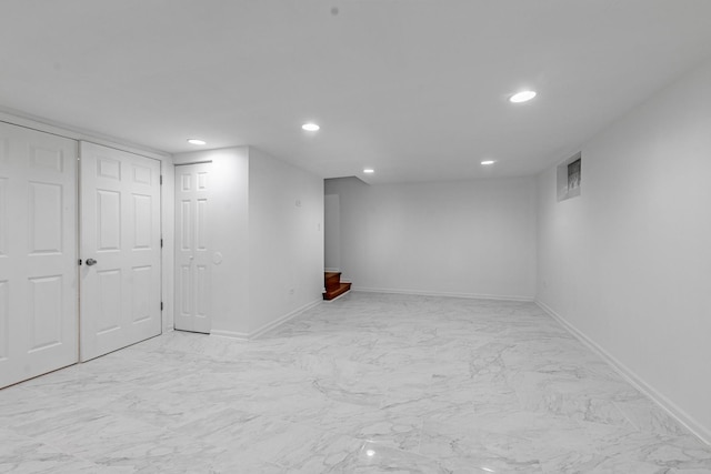 finished basement with marble finish floor, baseboards, and recessed lighting