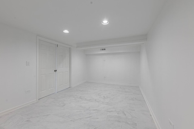 empty room featuring baseboards, marble finish floor, visible vents, and recessed lighting