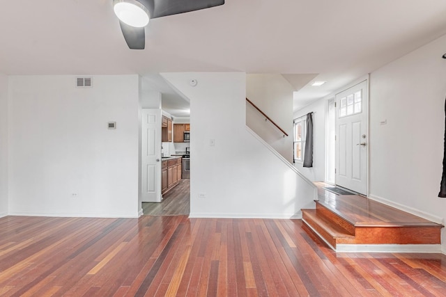 entryway featuring stairway, baseboards, visible vents, and hardwood / wood-style floors