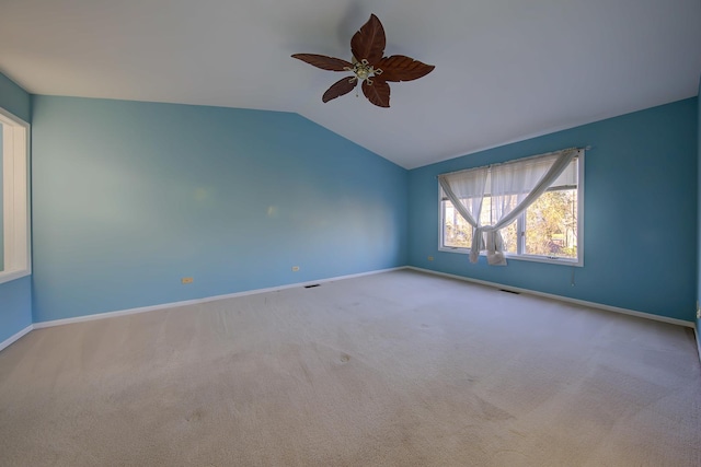 unfurnished room with baseboards, visible vents, vaulted ceiling, and carpet flooring