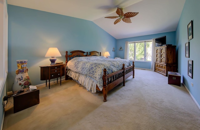 bedroom with lofted ceiling, light carpet, ceiling fan, and baseboards