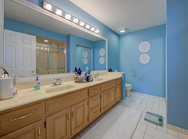 full bath with tile patterned flooring, a sink, a shower stall, and double vanity