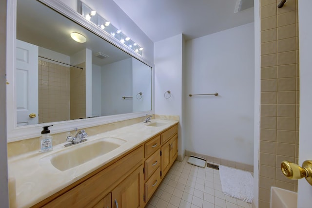 full bathroom featuring double vanity, visible vents, a sink, tile patterned flooring, and walk in shower