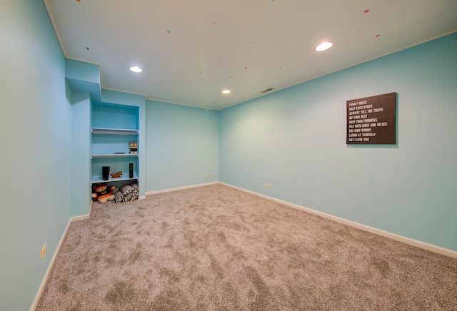 carpeted spare room featuring built in features, recessed lighting, and baseboards