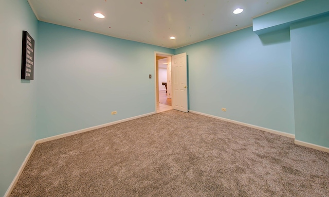 empty room with carpet floors, recessed lighting, and baseboards