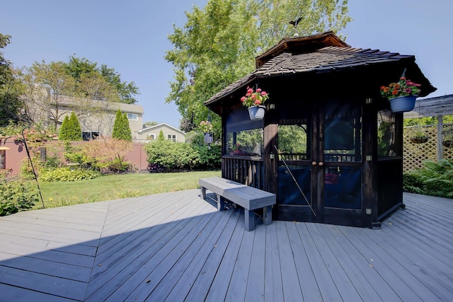 wooden terrace with a yard